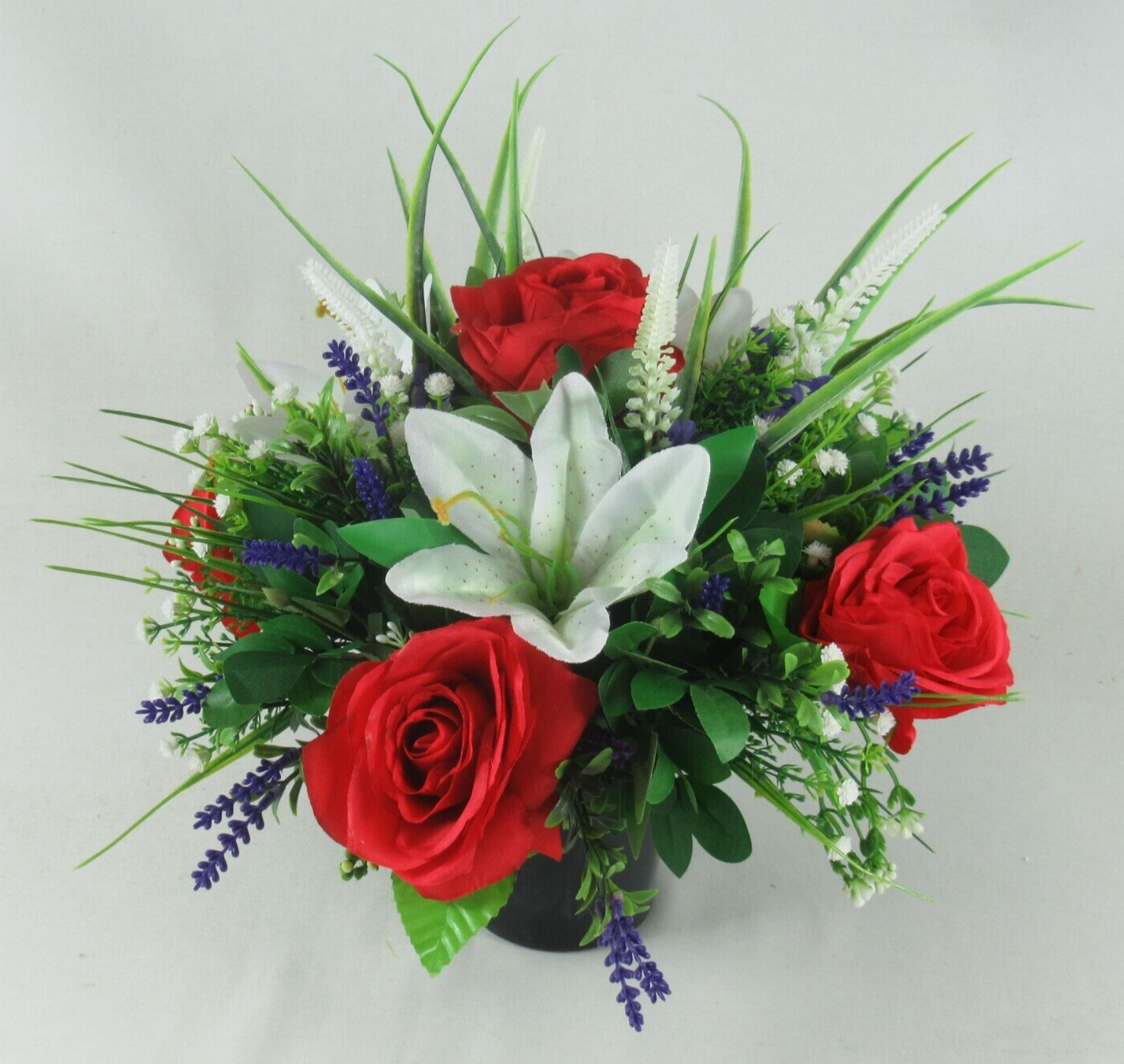 Artificial silk memorial urn bouquet: white lily, red roses, blue flower spikes