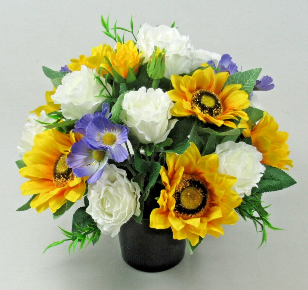 Artificial silk pot grave arrangement with yellow sunflowers, white roses, blue flowers and green foliage