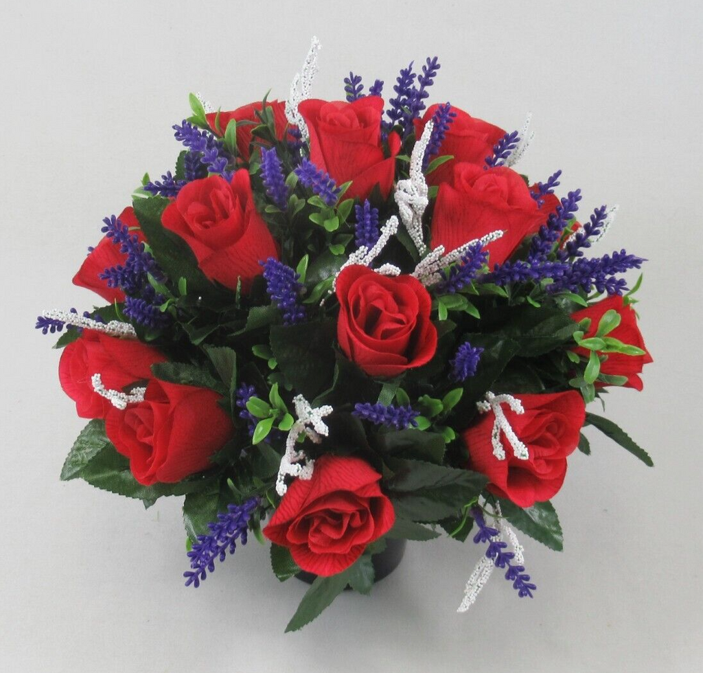 Red artificial rose memorial grave arrangement in black pot with purple spikes and white accents