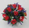 Red artificial rose memorial grave arrangement in black pot with purple spikes and white accents
