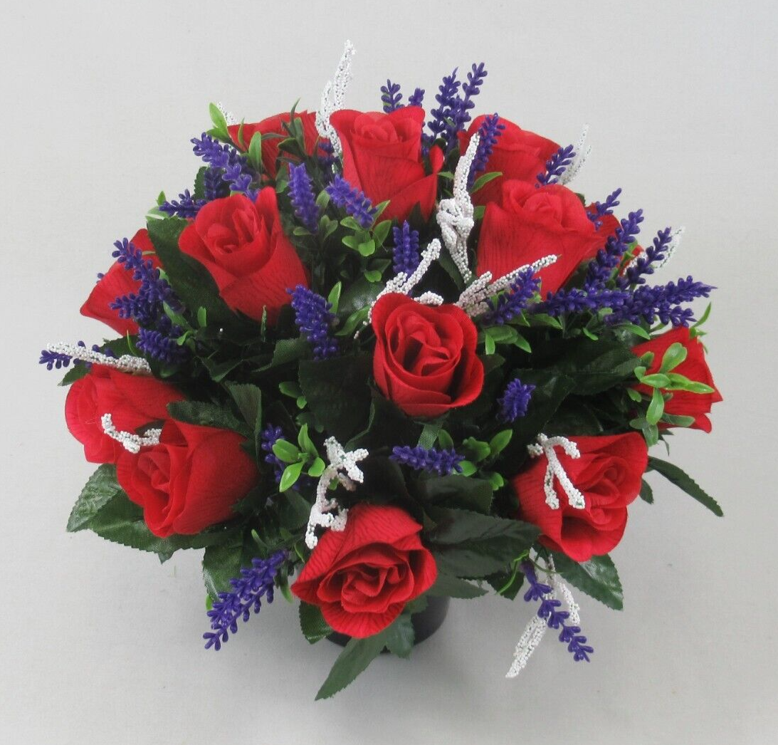 Red artificial rose memorial grave arrangement in black pot with purple spikes and white accents
