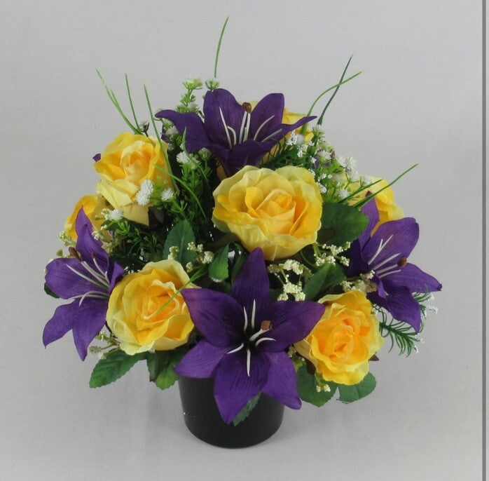 Artificial grave pot bouquet with yellow roses and purple lily blooms, leafy filler