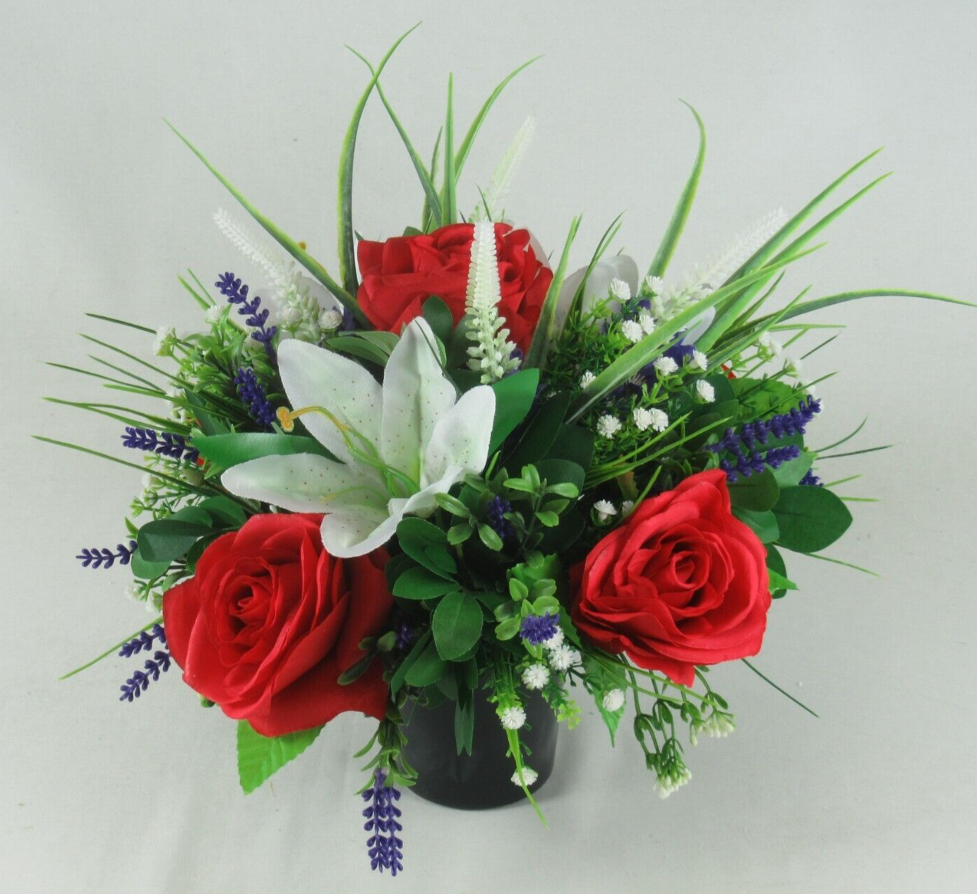 Black urn crem pot arrangement: red roses, white lily, blue lavender blooms