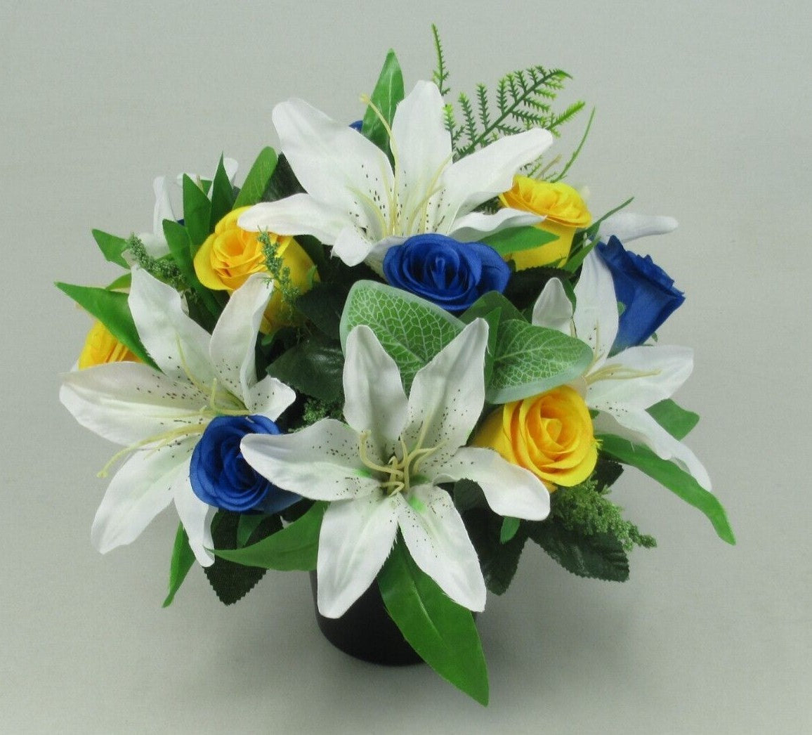 Artificial silk memorial grave pot with white lilies, yellow and blue roses, green foliage