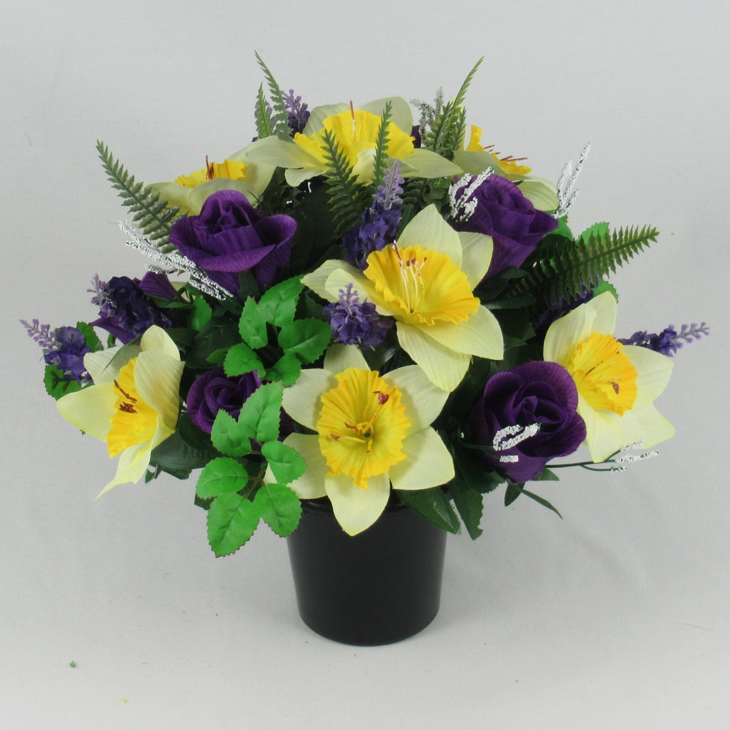 Memorial grave pot with yellow daffodil-style flowers, purple roses, green leaves and lavender buds