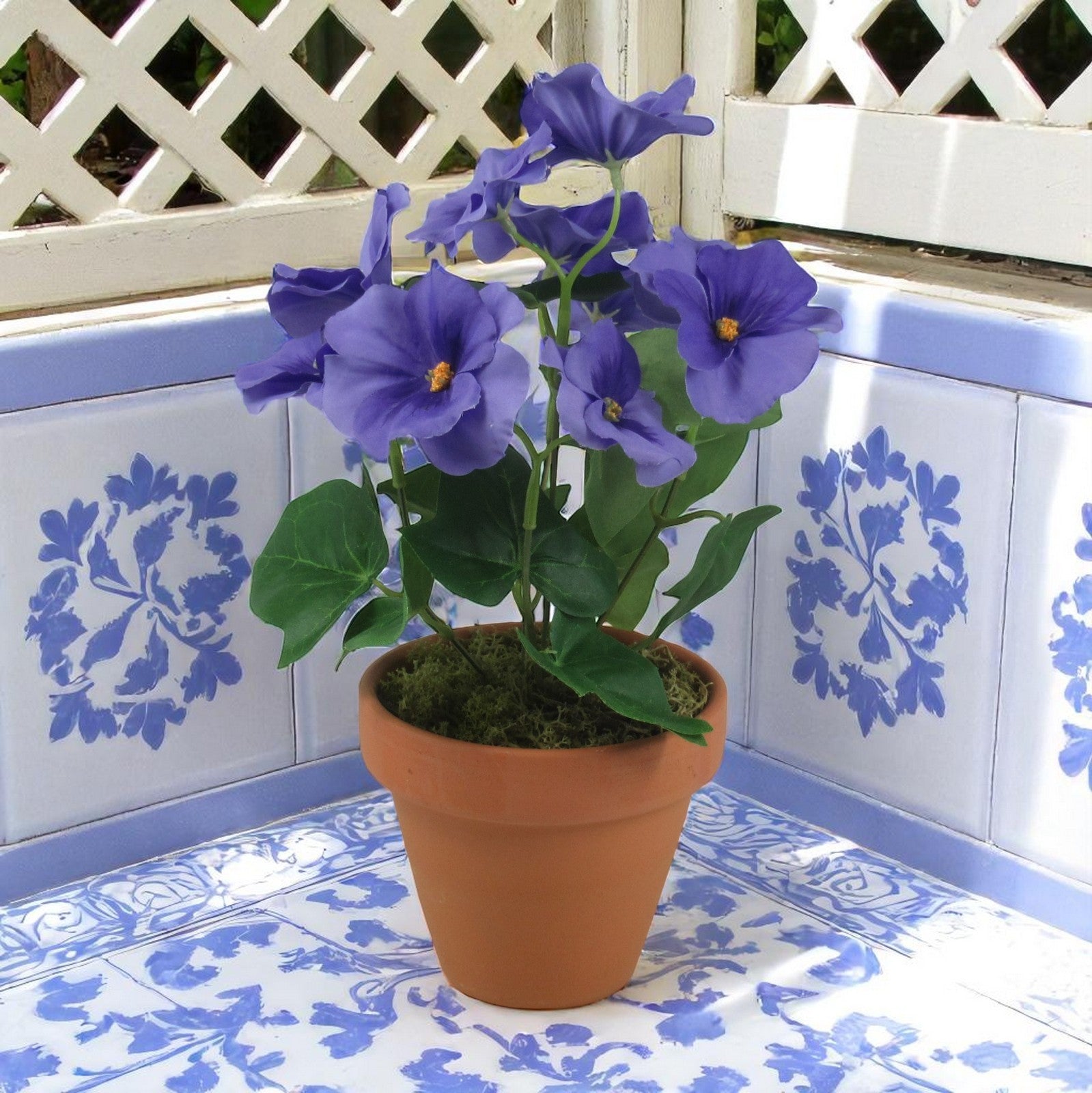 Artificial silk pansy bunch with purple-blue blossoms and green leaves
