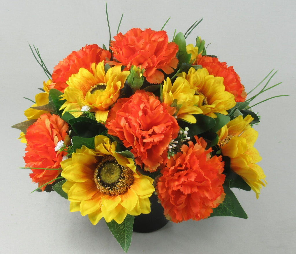 Artificial memorial grave pot arrangement with orange and yellow sunflowers and carnations