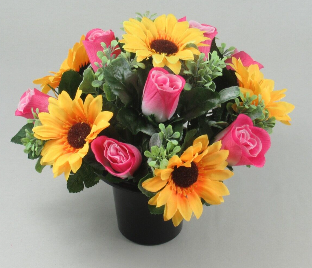 Black cremation pot with artificial yellow sunflowers, pink roses, and green foliage