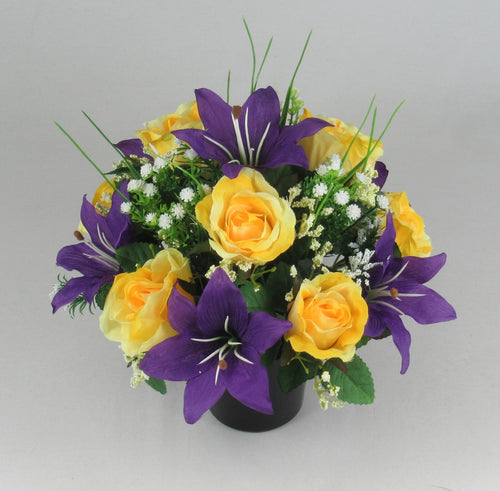 Artificial grave memorial arrangement in dark pot with yellow roses, purple lilies, white filler flowers