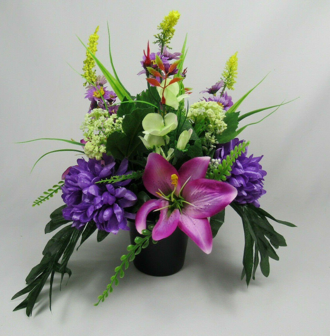 Modern style grave flower arrangement with purple chrysanthemums artificial