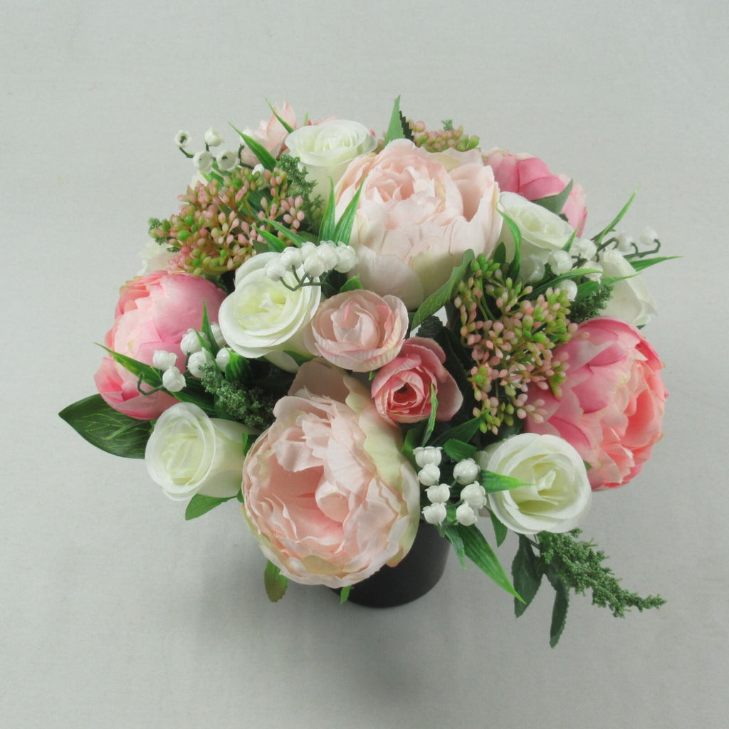 Artificial silk memorial pot bouquet, cream and pink roses with greenery, black container