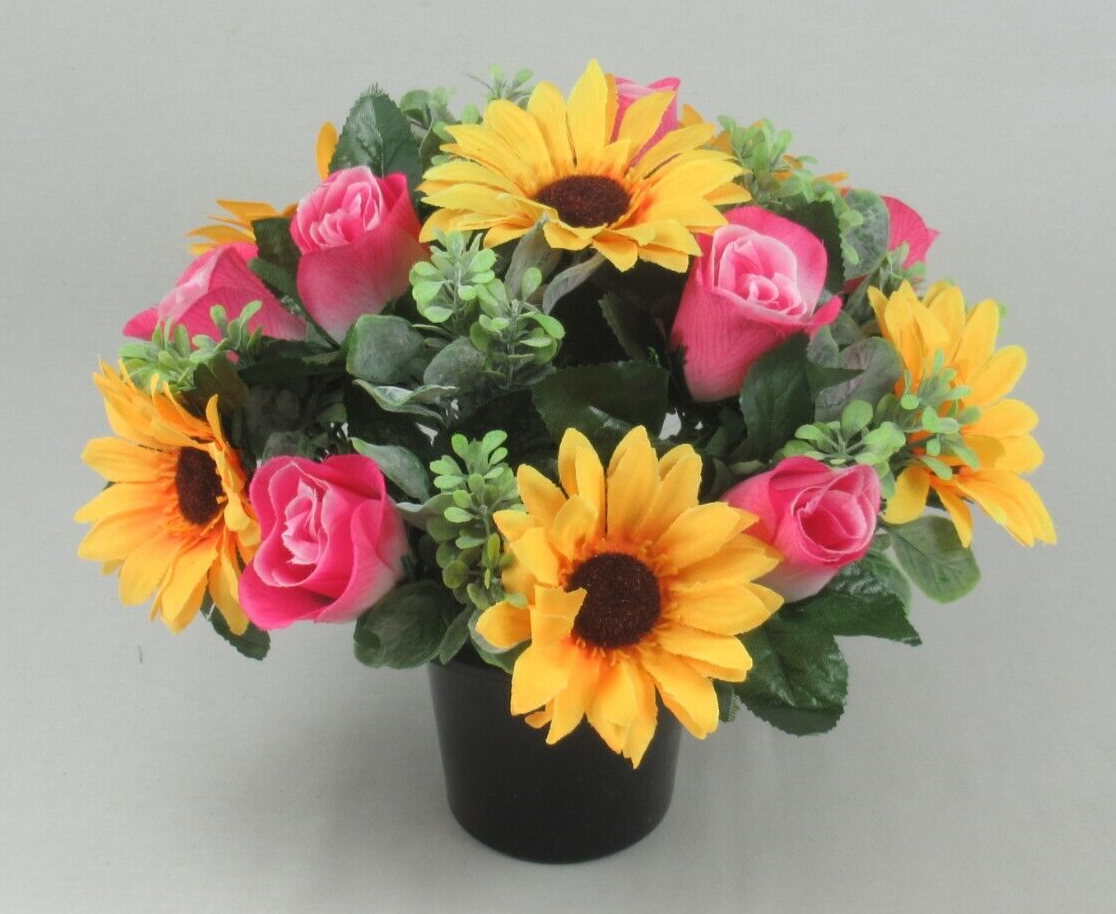 Black crem pot centerpiece with artificial yellow sunflowers, pink roses, and leafy greenery