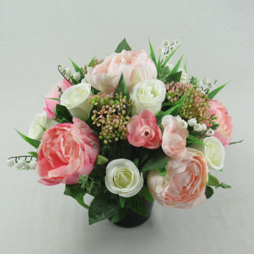Artificial silk grave flower arrangement in black pot with soft pink and white blossoms