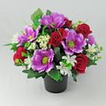Memorial grave artificial silk flowers in black pot with purple, red & white blooms