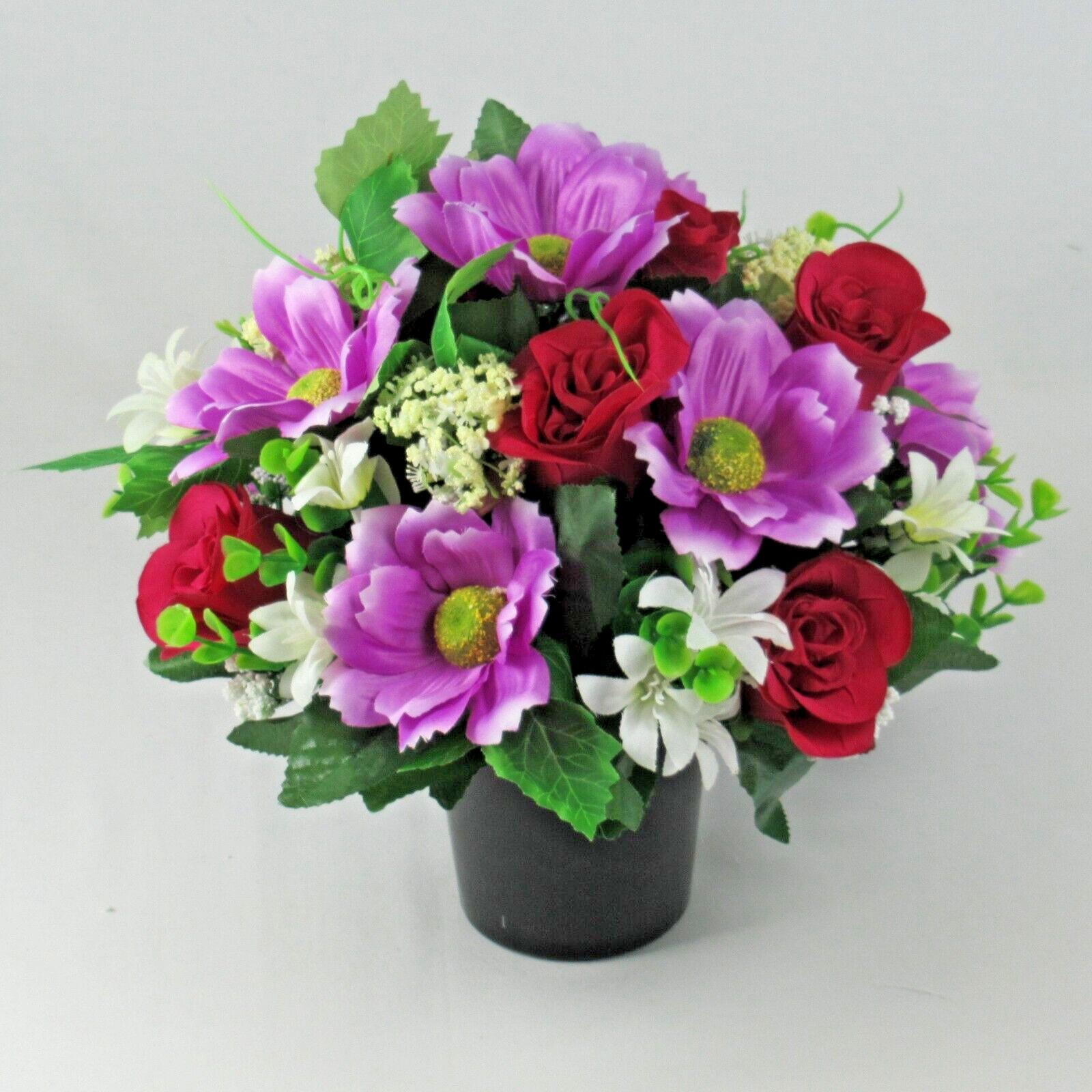 Memorial grave artificial silk flowers in black pot with purple, red & white blooms