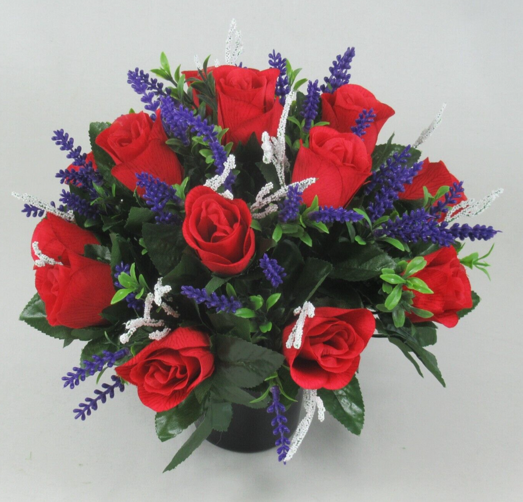 Front-centered view: red artificial roses in black pot with purple lavender spikes and white tinsel