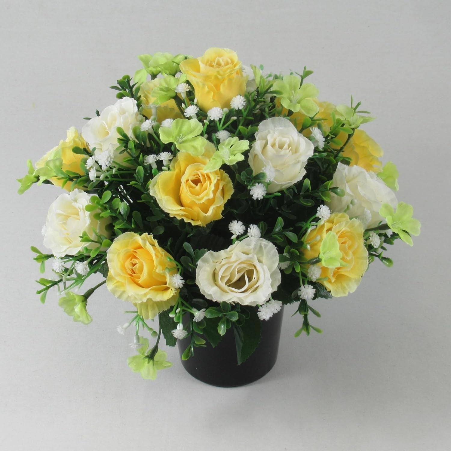 Artificial silk rose memorial crem pot with pale yellow and white roses, green leaves, black pot