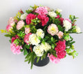Artificial mini-carnation grave memorial pot bouquet with pink and white blooms, dark pot