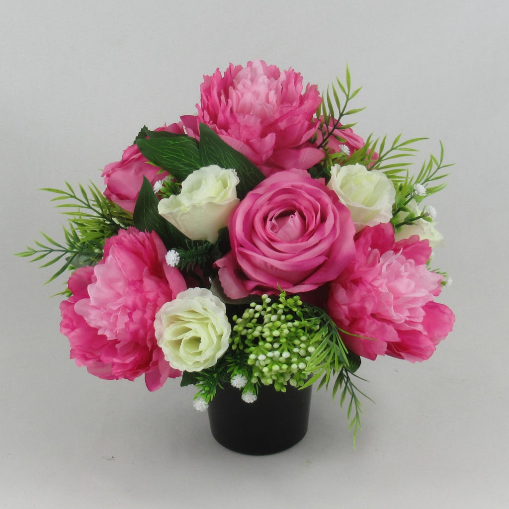 Pink and cream artificial rose and peony grave memorial bouquet in black vase