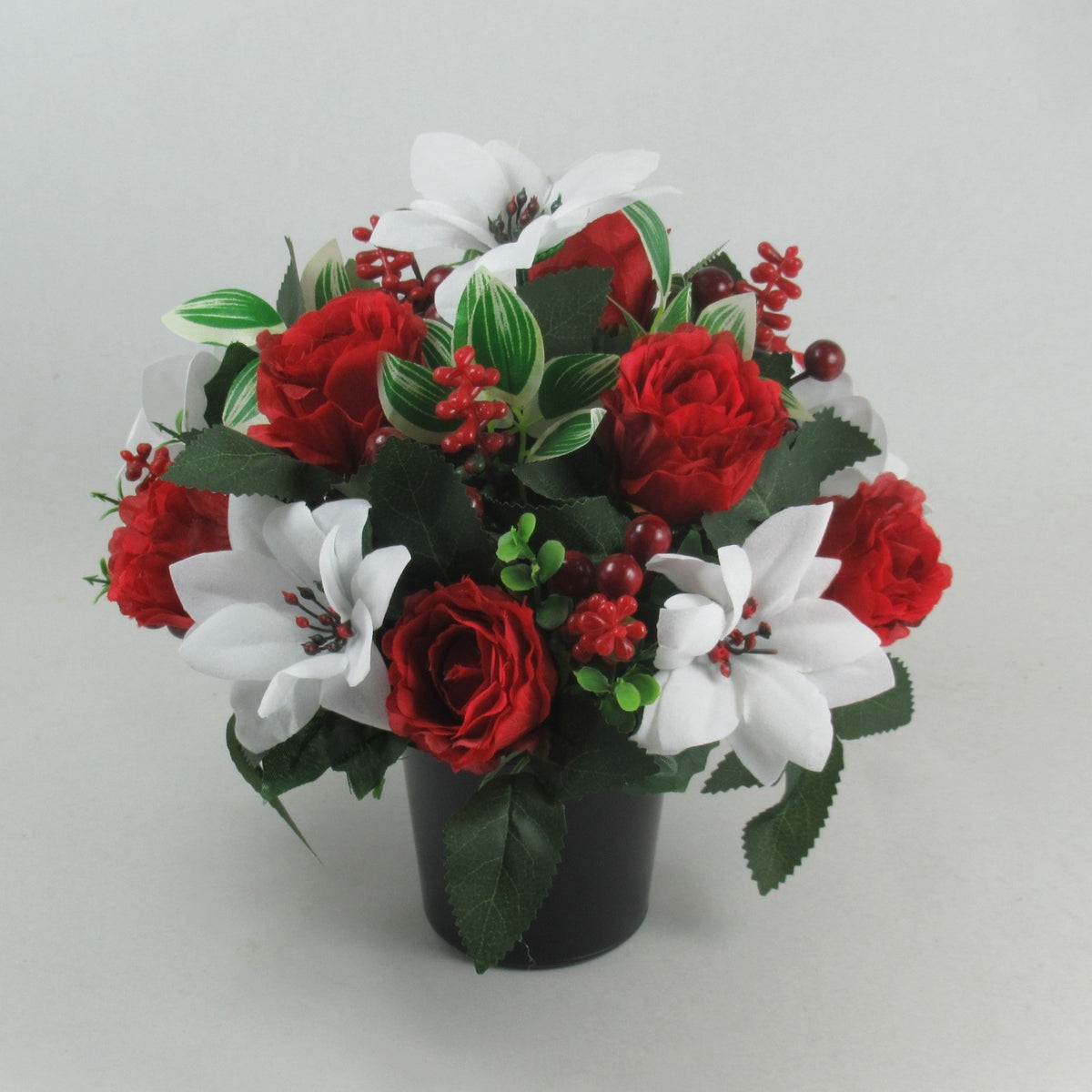 Long-lasting grave flower arrangement in dark pot with red roses, white blooms, green leaves