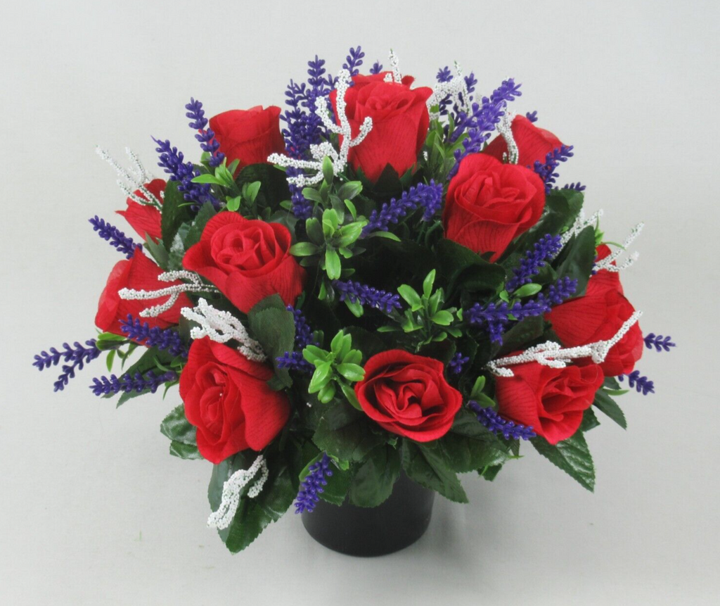 Front view artificial grave arrangement in black pot with red roses, purple flowers, white spray