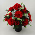 Artificial red rose & carnation memorial arrangement with white filler, in black pot