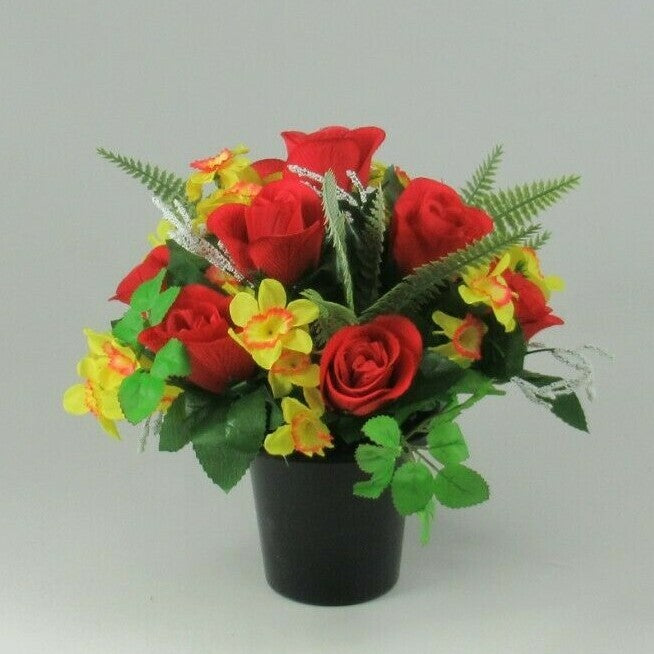 Front view artificial grave arrangement with red roses and yellow blooms in black pot