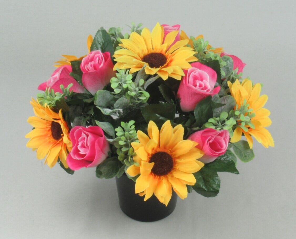 Artificial grave arrangement in black pot with yellow sunflowers, pink roses, and green leaves