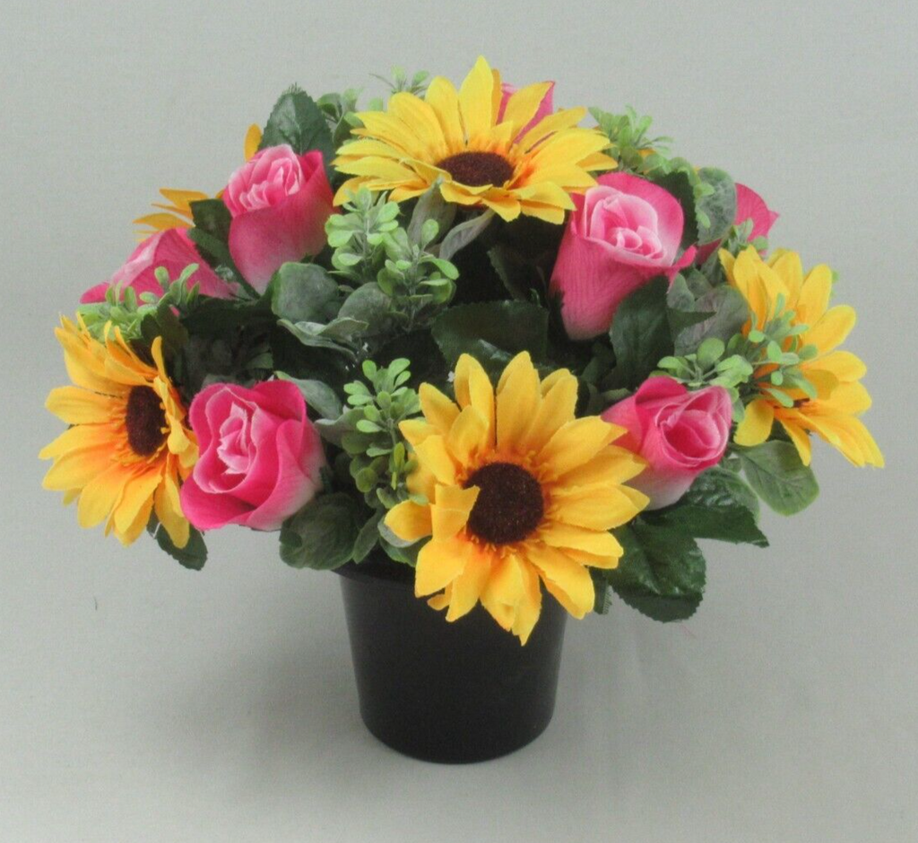 Artificial flower crem pot with yellow sunflower heads and pink rose blooms in black container