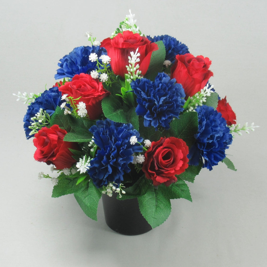 Artificial grave pot arrangement with red roses and royal blue carnations, white filler