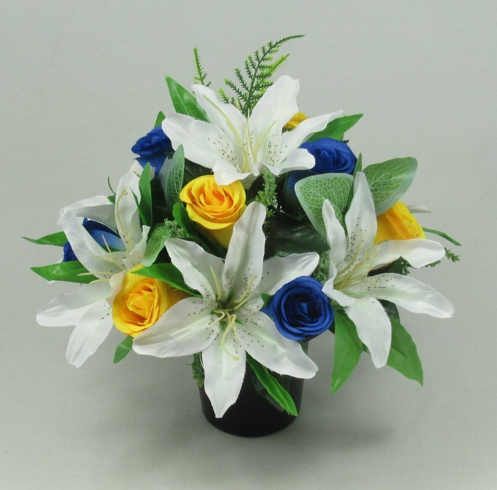 Artificial silk grave pot centerpiece with white lilies, blue roses, yellow roses, green greenery