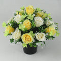 Artificial silk rose memorial crem pot with yellow/white/green blossoms in black planter