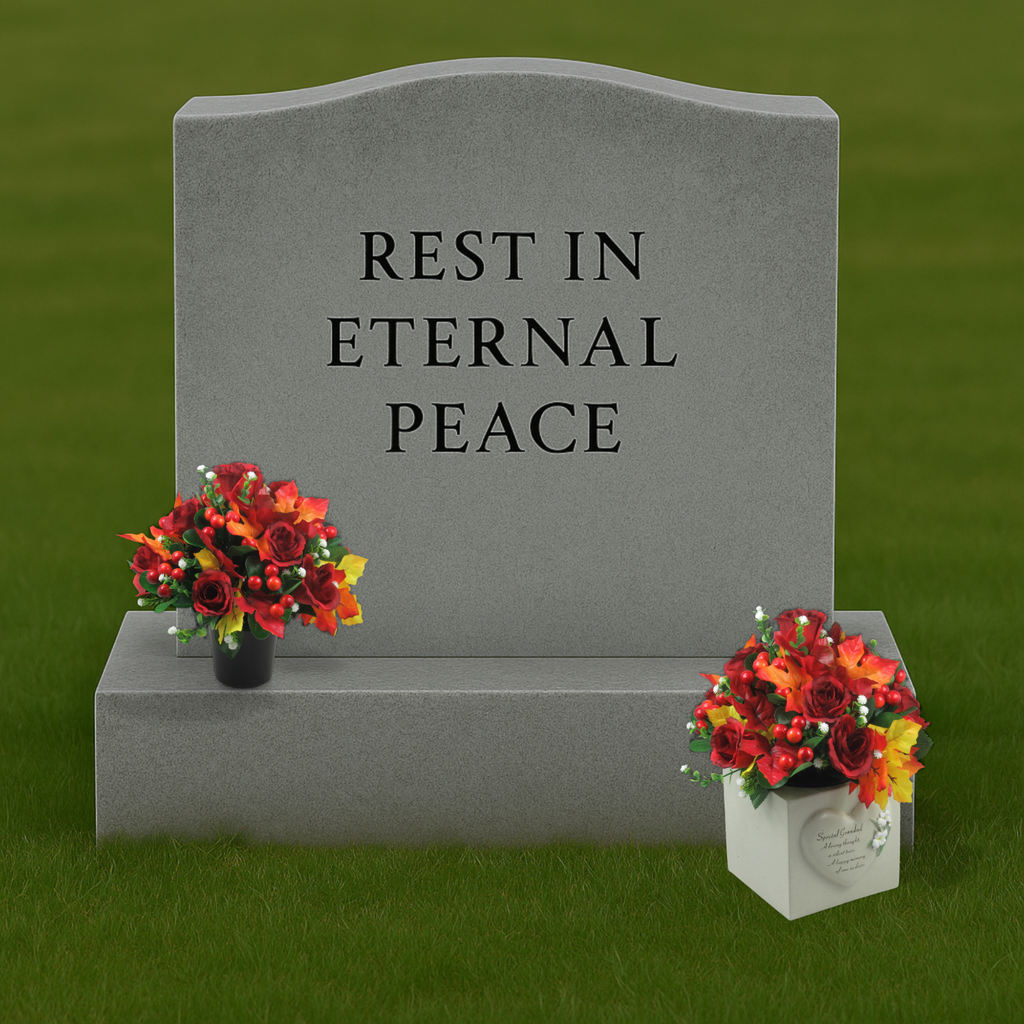 Small artificial grave floral arrangement with red roses and berries in black pot on a stone base