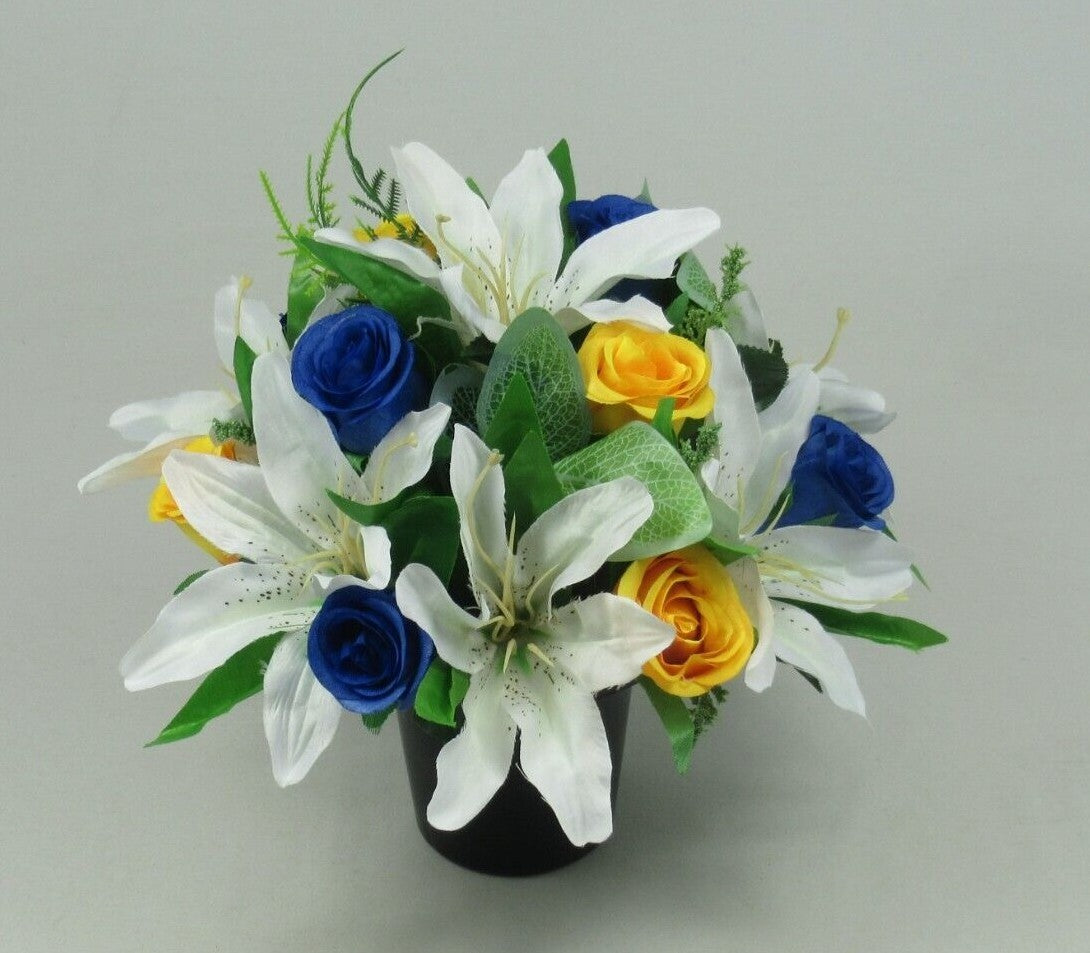 Artificial silk grave arrangement in black pot with white lilies, blue roses, yellow roses and leaves