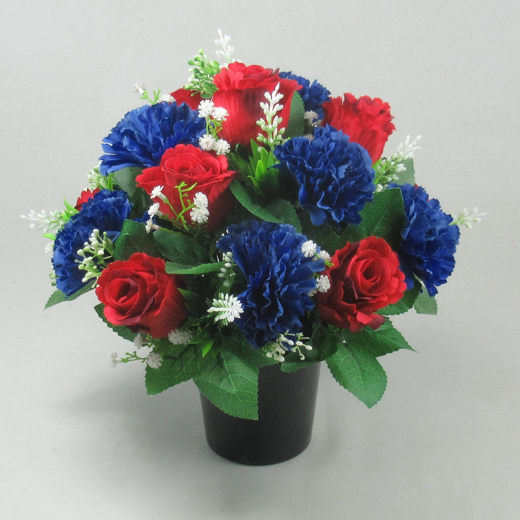 Cremation memorial flower pot with red roses, blue carnations, white sprigs, green foliage