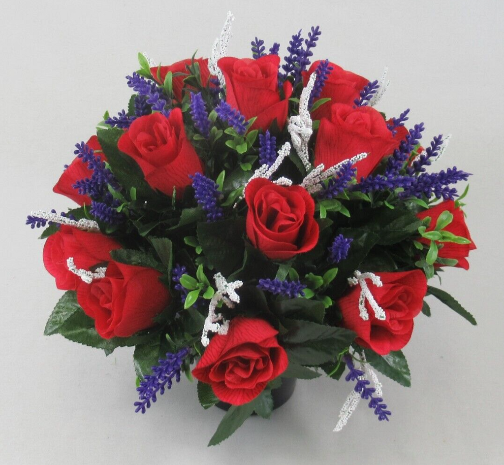 Overhead view artificial memorial grave pot with red roses, purple spikes, green leaves, white stems