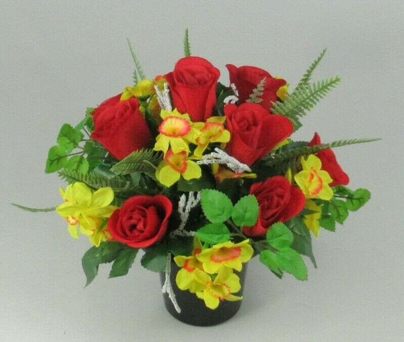 Side view artificial flower arrangement with red roses and yellow blooms in black pot