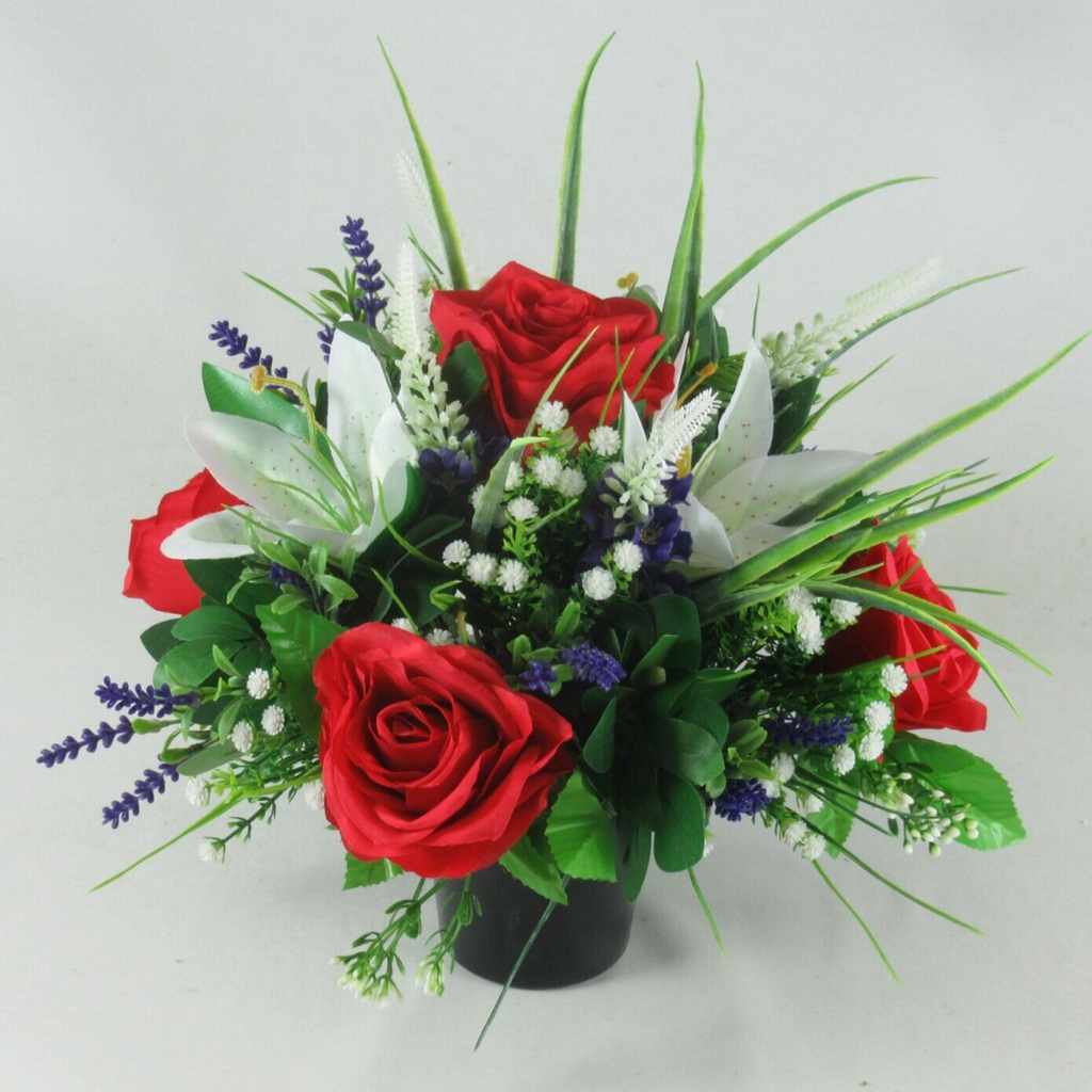 Black urn grave arrangement with two red roses, white lily, blue lavender accents