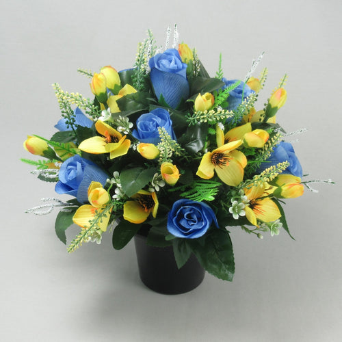 Grave pot flower arrangement with blue roses, yellow blooms, and greenery in black pot