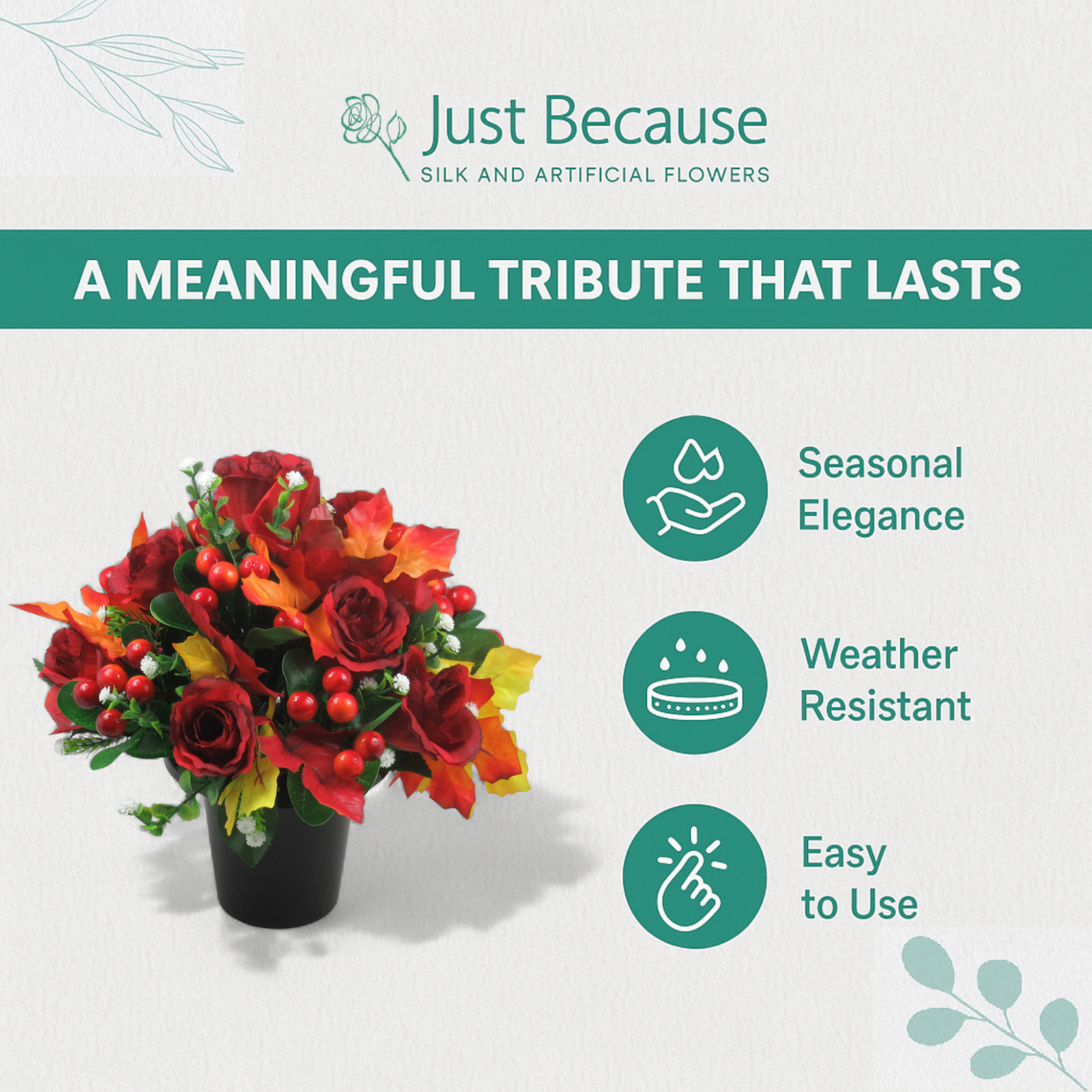 Red rose and berry artificial grave arrangement in a black pot with autumn leaf accents