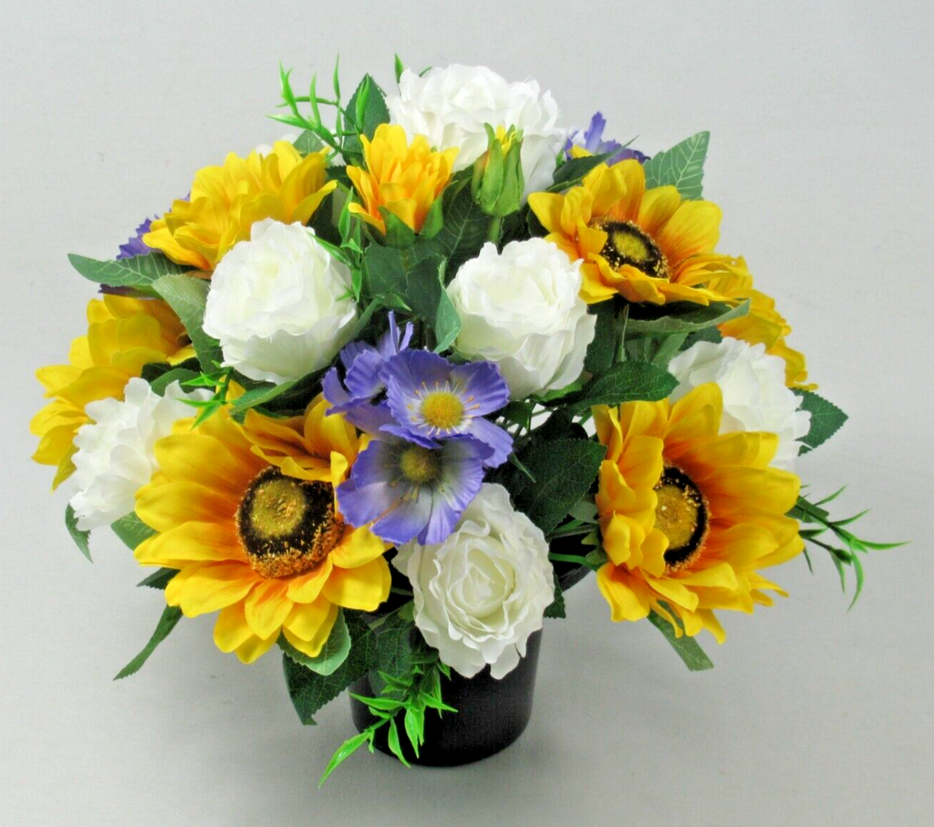 Artificial silk memorial bouquet in black pot with yellow sunflowers, white roses, and blue flower buds
