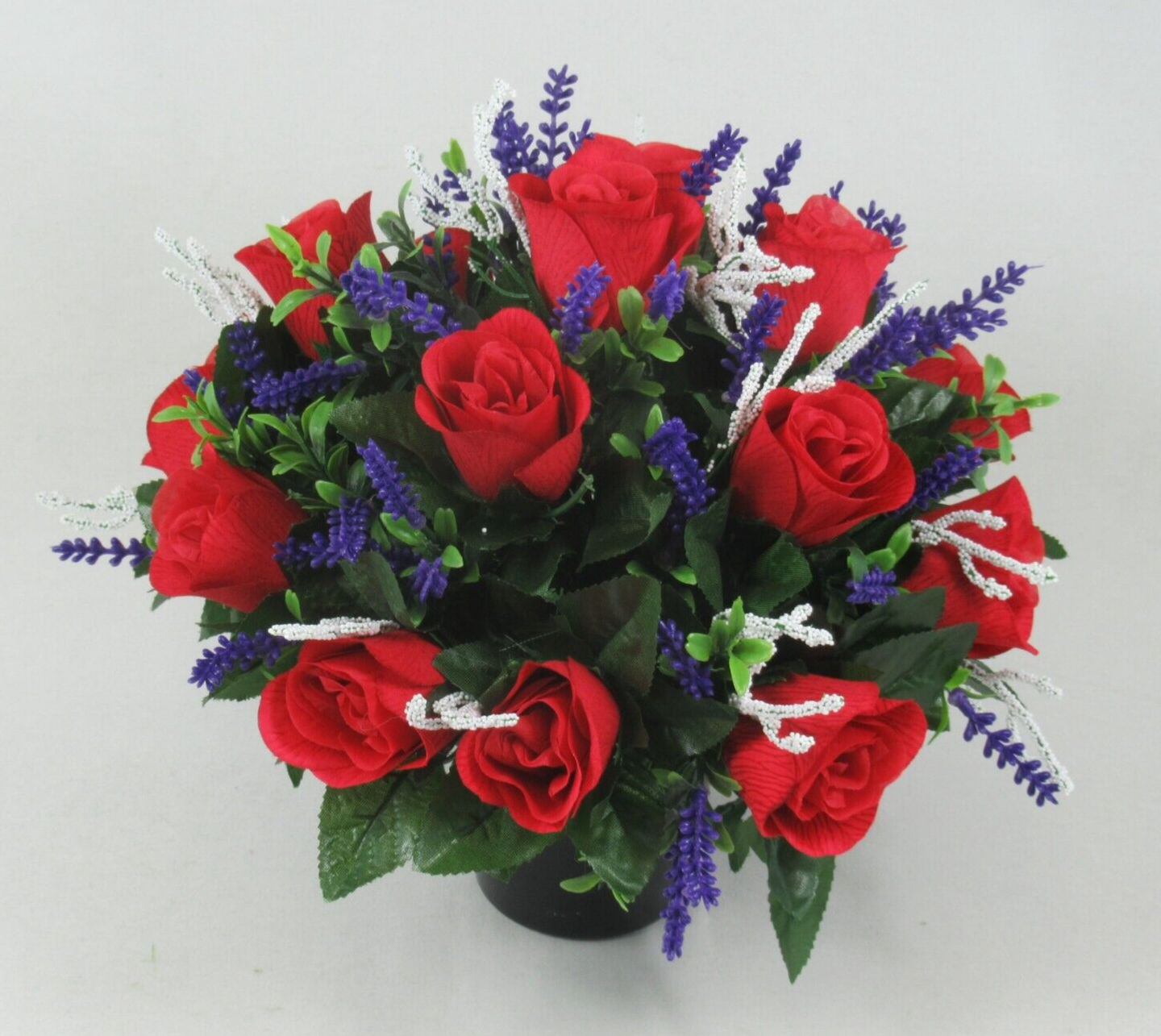 Wide view memorial grave pot arrangement with red roses, purple spikes, white glitter branches