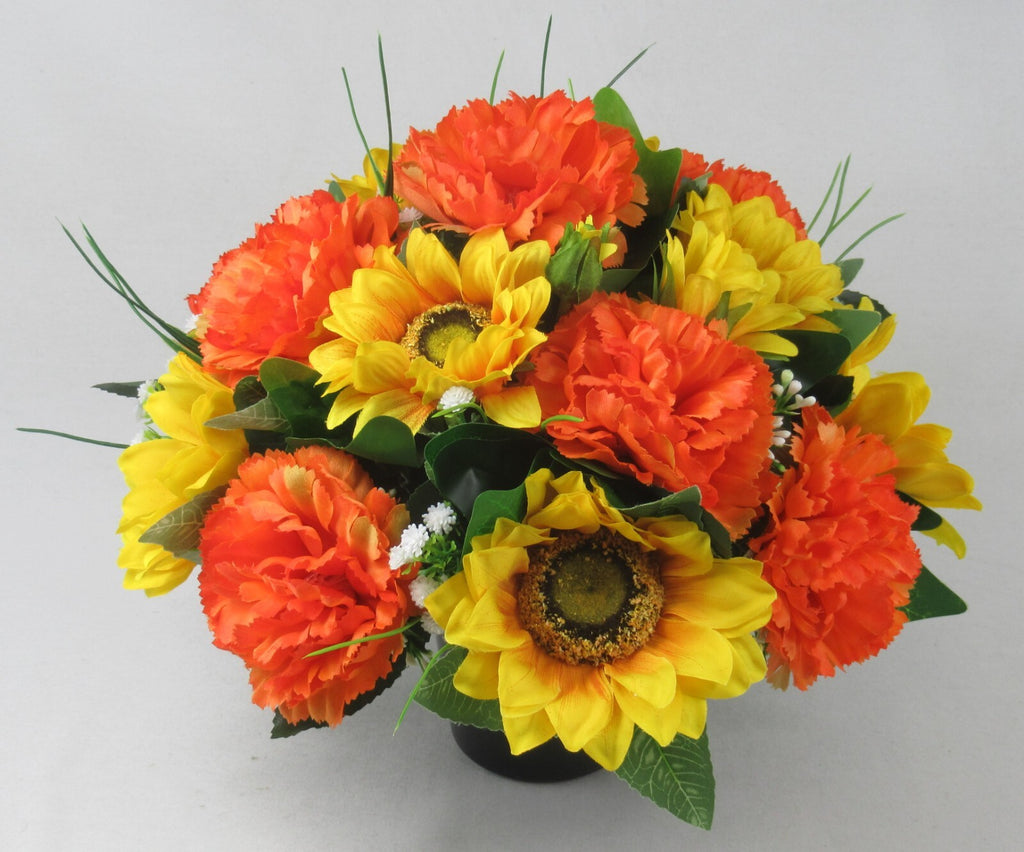 Artificial memorial grave pot floral arrangement with orange and yellow flowers and green leaves
