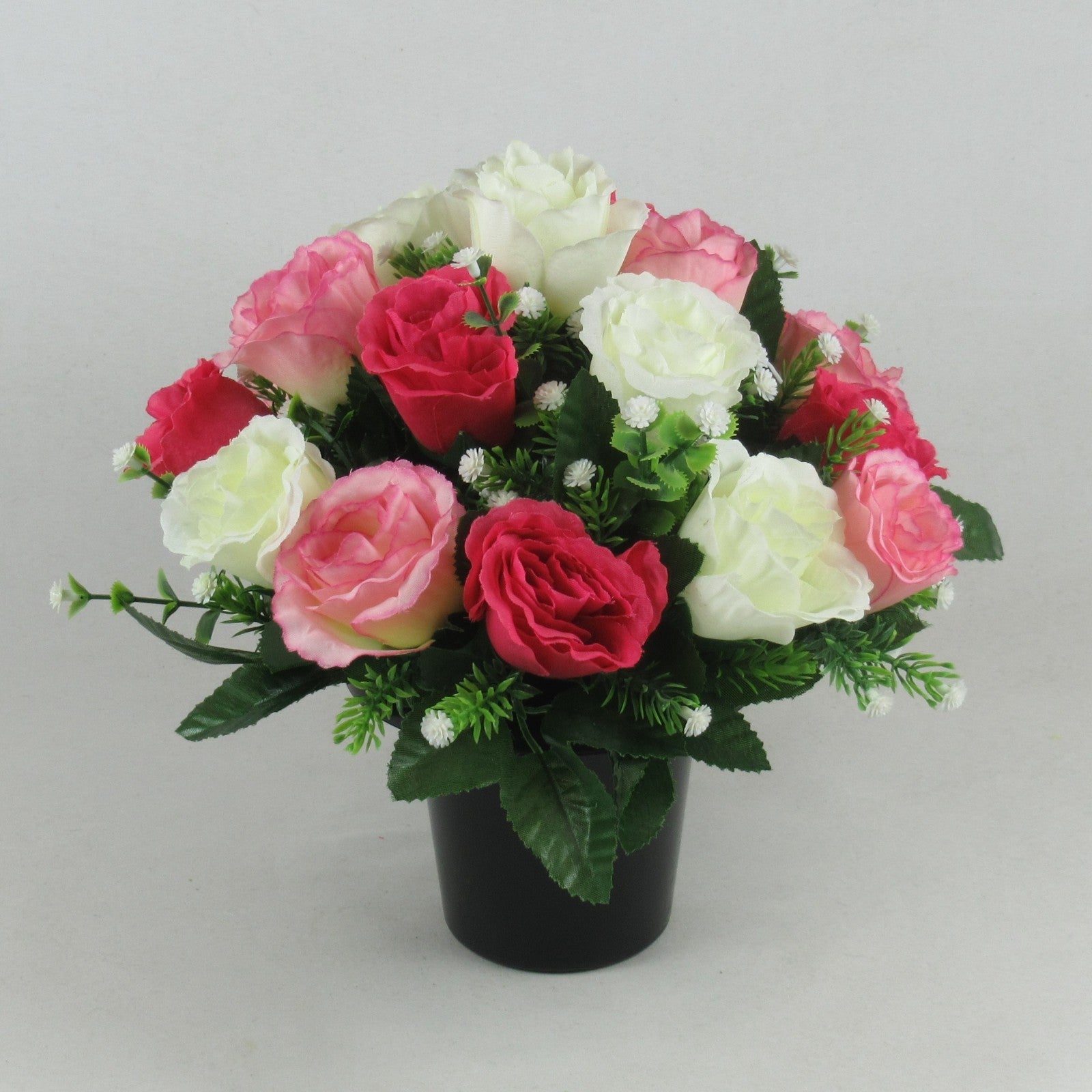 Artificial rose and rosebud memorial arrangement with pink, ivory and red blooms in black vase