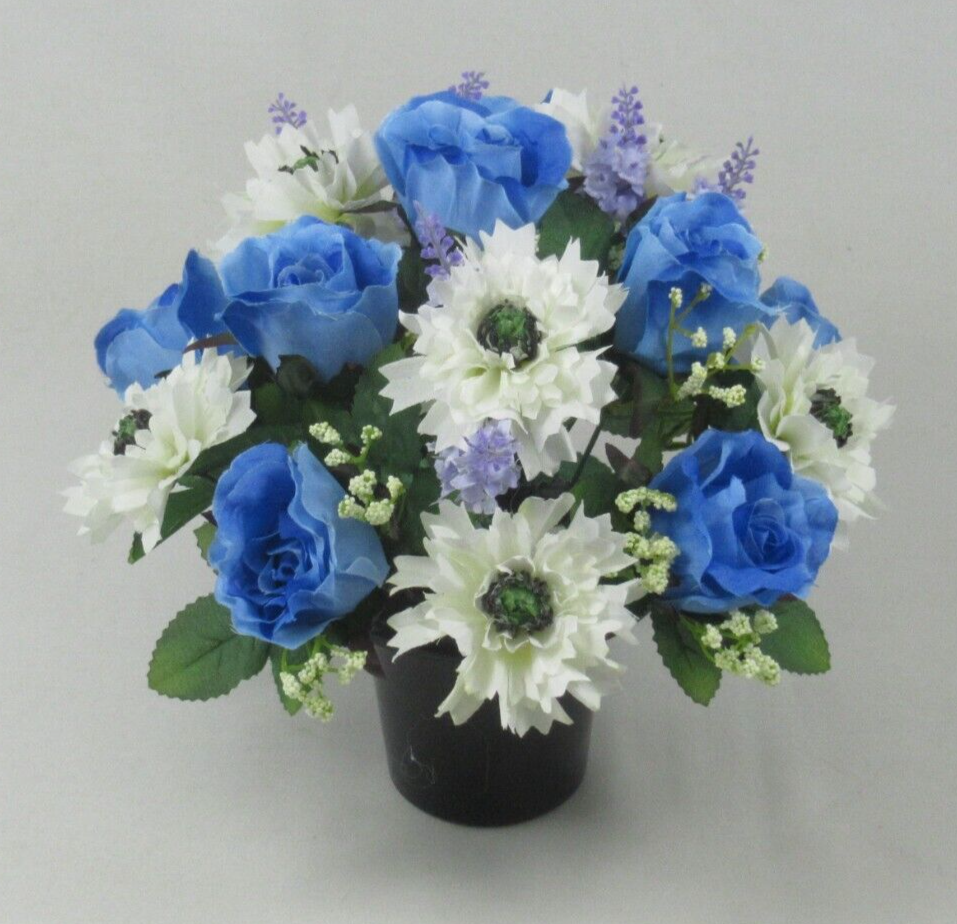 Front view of artificial grave pot bouquet with blue rose blooms, white flowers, green leaves