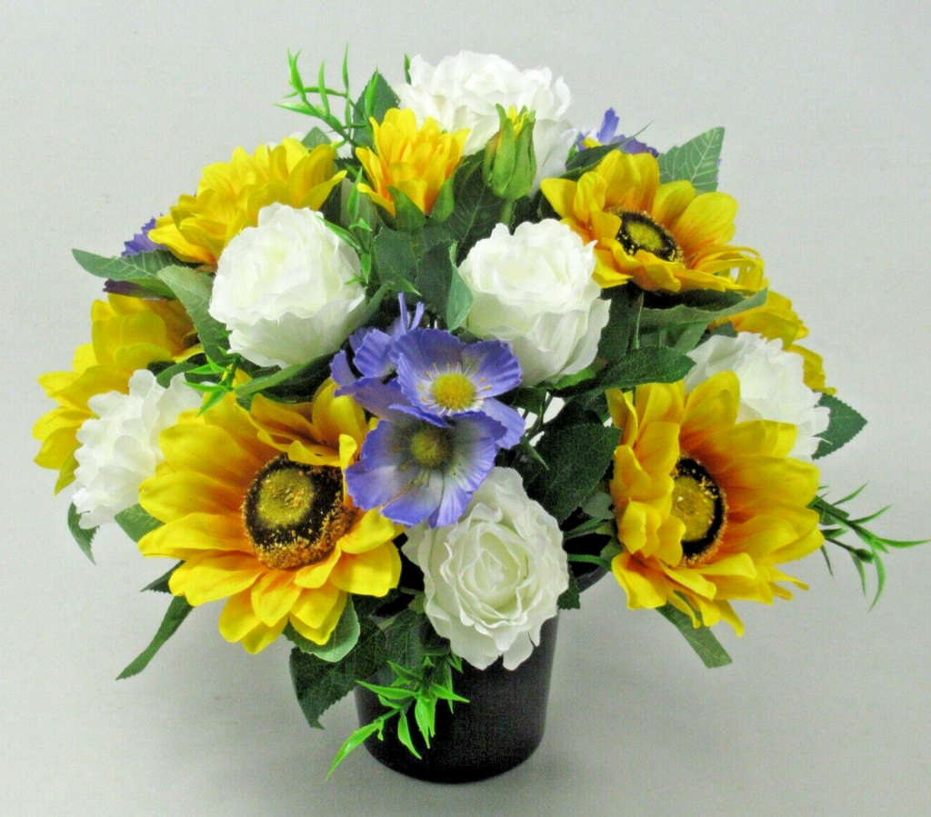 Artificial silk grave arrangement in black pot: bright yellow sunflowers, white roses, blue blossoms