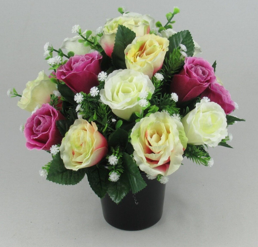 Artificial silk rose grave arrangement in black pot, cream, pale yellow, and magenta roses