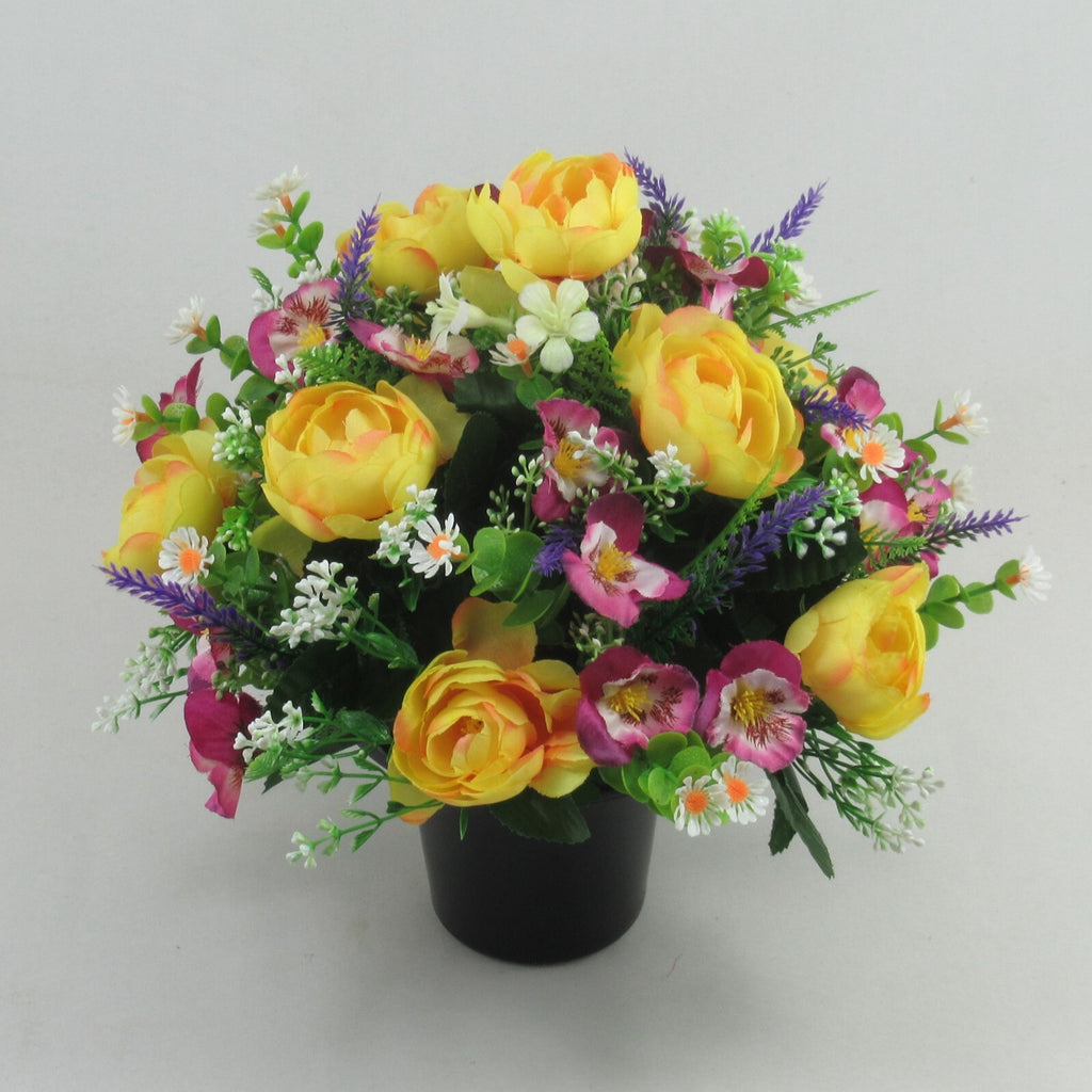 Artificial memorial arrangement: yellow roses, pink-purple flowers, lavender spikes in black pot