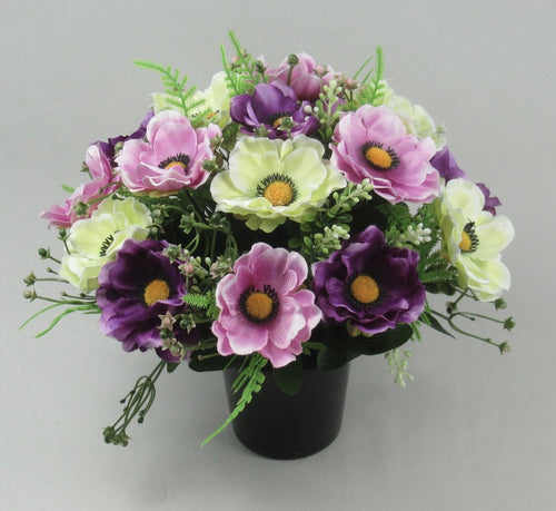 Artificial grave anemone arrangement with light green, pink, and dark purple flowers in black pot