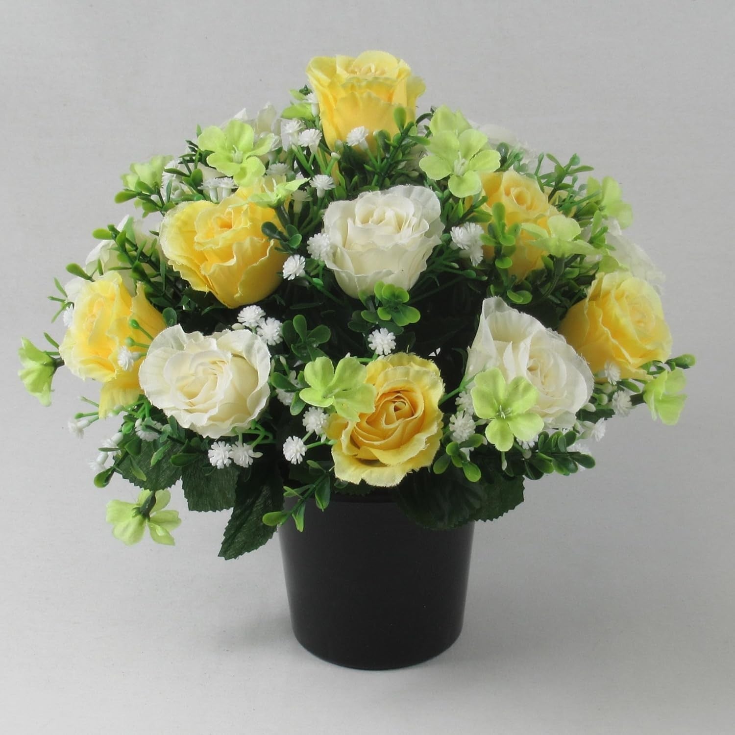 Artificial silk rose memorial crem pot with white and yellow roses plus lime flowers, black pot